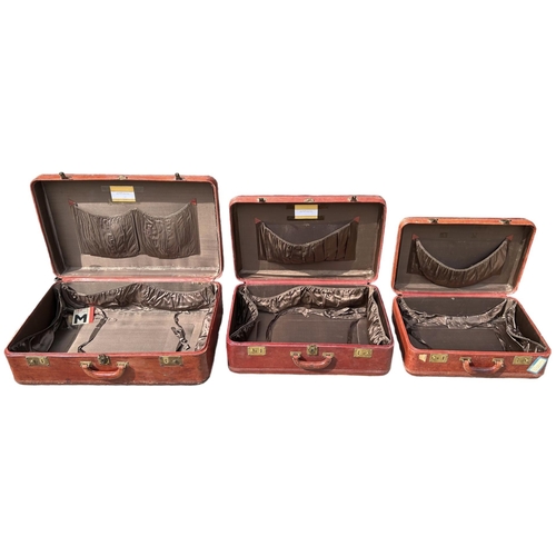 164 - A SET OF THREE GRADUATED MATCHING TAN LEATHER SUITCASES. 
(largest 75cm x 48cm x 23.5cm, medium 63cm... 