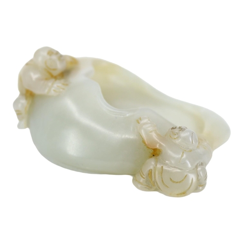122 - A CHINESE GREENISH-WHITE JADE ‘PEACH & BOYS’ BRUSH WASHER CARVING
Two boys climbing to mouth rim, on... 