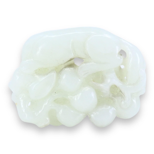 125 - A CHINESE WHITE JADE 'SQUIRREL AND GRAPE' GROUP CARVING
The pebble carved, pierced and partially hol... 