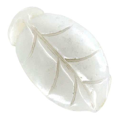 127 - A CHINESE WHITE JADE ‘BOY ON LEAF’ CARVED PENDANT
The pendant depicting a boy clinging onto the stem... 