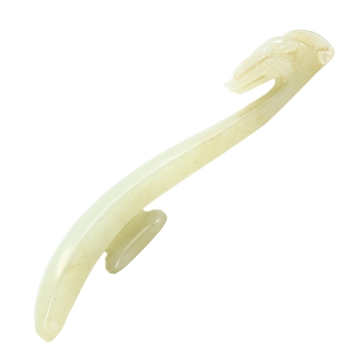 130 - A CHINESE PALE GREEN JADE DRAGON OR PHOENIX HEAD BELT HOOK. 
(length 9.5cm)