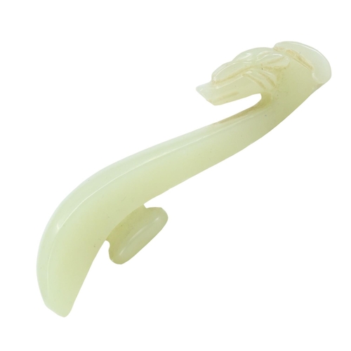 131 - A CHINESE PALE GREEN JADE DRAGON OR PHOENIX HEAD BELT HOOK. 
(length 7.7cm)