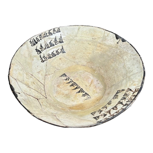 152 - IRAN 9TH-10TH CENTURY, A LARGE NISHAPUR POTTERY BOWL 
Having three sets of floriated Kufic inscripti... 