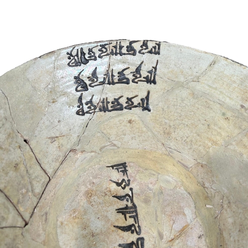 152 - IRAN 9TH-10TH CENTURY, A LARGE NISHAPUR POTTERY BOWL 
Having three sets of floriated Kufic inscripti... 