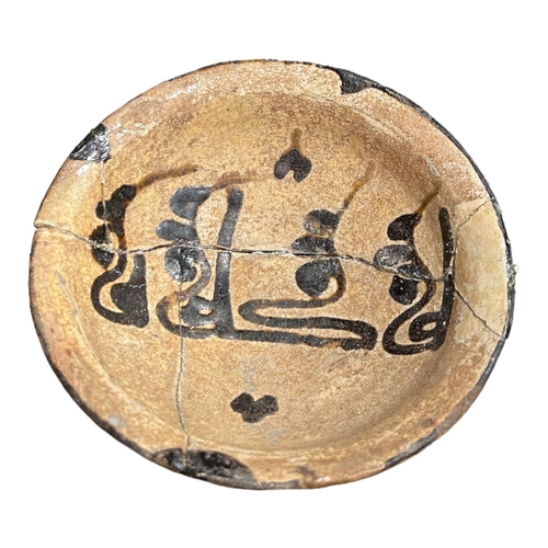 153 - IRAN 9TH-10TH CENTURY, A NISHAPUR POTTERY BOWL 
Having central floriated Kufic inscriptions, remnant... 