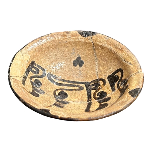153 - IRAN 9TH-10TH CENTURY, A NISHAPUR POTTERY BOWL 
Having central floriated Kufic inscriptions, remnant... 