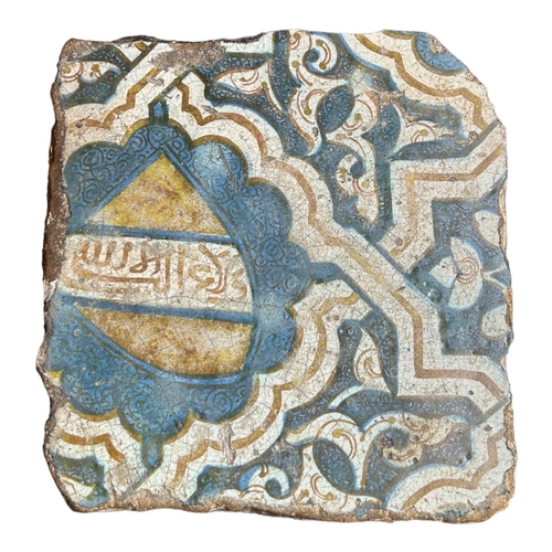 154 - A SPANISH, SEVILLE 16TH CENTURY NASRID TILE
Painted in yellow, blue and white with a shield cartouch... 