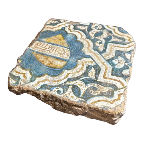 154 - A SPANISH, SEVILLE 16TH CENTURY NASRID TILE
Painted in yellow, blue and white with a shield cartouch... 
