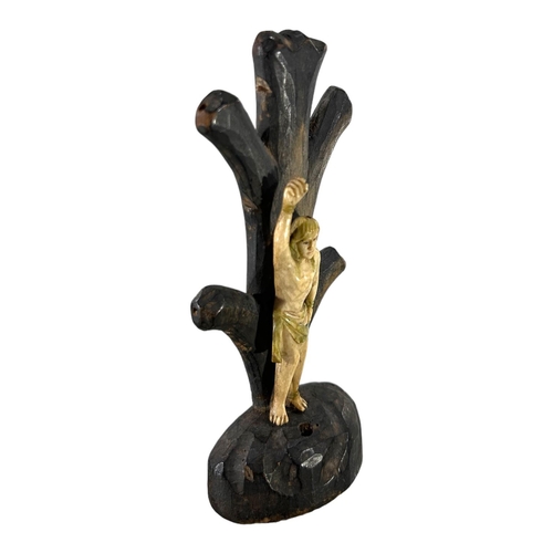 171 - AN 18TH /19TH CENTURY CONTINENTAL BONE AND WOOD CARVING OF ST SEBASTIAN TIED AGAINST A TREE. 
(h 15.... 