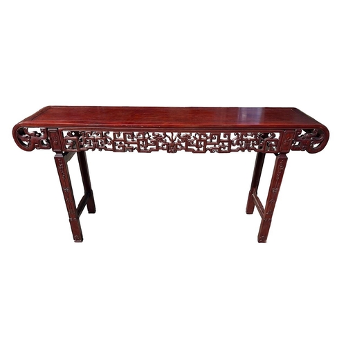 218 - A LARGE CHINESE HARDWOOD ALTAR TABLE
The plank top above a carved and priced frieze and scrolling dr... 