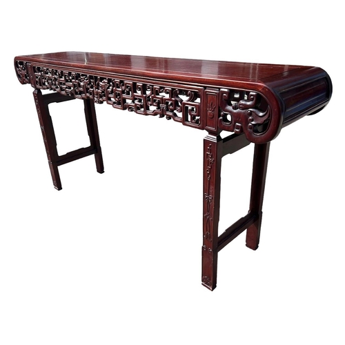 218 - A LARGE CHINESE HARDWOOD ALTAR TABLE
The plank top above a carved and priced frieze and scrolling dr... 