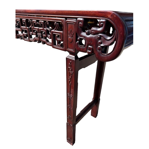 218 - A LARGE CHINESE HARDWOOD ALTAR TABLE
The plank top above a carved and priced frieze and scrolling dr... 