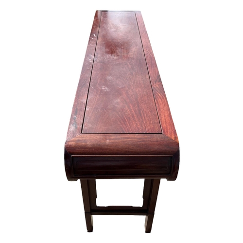218 - A LARGE CHINESE HARDWOOD ALTAR TABLE
The plank top above a carved and priced frieze and scrolling dr... 
