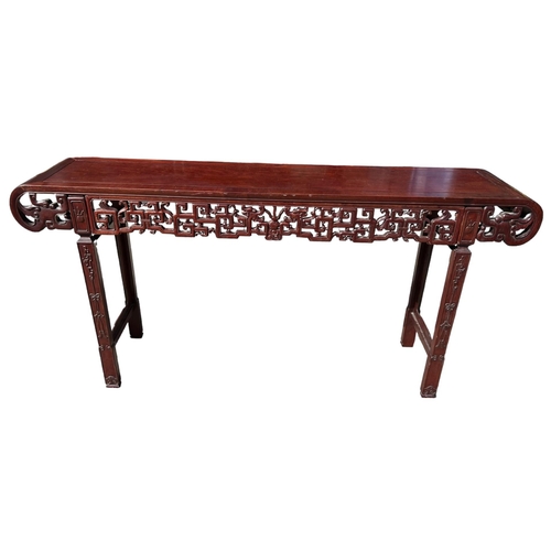 218 - A LARGE CHINESE HARDWOOD ALTAR TABLE
The plank top above a carved and priced frieze and scrolling dr... 