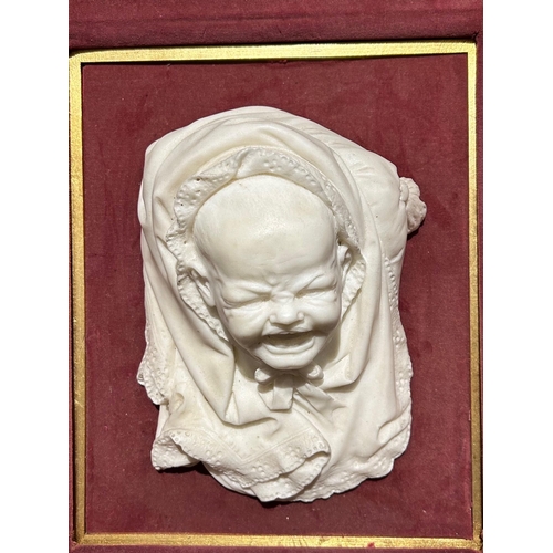 213 - A 19TH CENTURY CARVED PORTRAIT BUST OF A BABY CRYING IN SHAWL, TITLED ‘THE PIN THAT PRICKS’ FROM THE... 