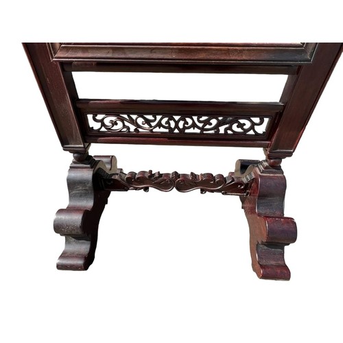 225 - A CHINESE CARVED HARDWOOD CHEVELLE MIRROR
Decorated with scrolling foliage, raised on scrolling feet... 