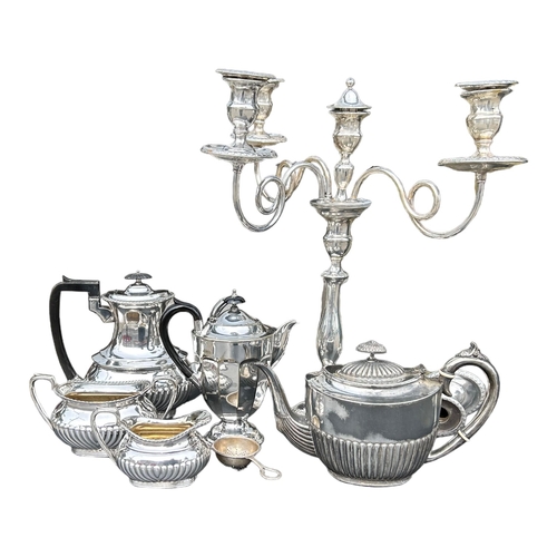 34 - A COLLECTION OF SILVER PLATED ITEMS COMPRISING TWO TEAPOTS, COFFEE POT, MILK JUG, SUGAR BOWL, CANDEL... 