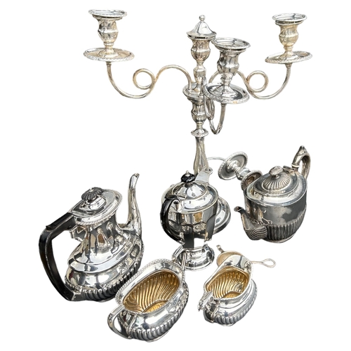 34 - A COLLECTION OF SILVER PLATED ITEMS COMPRISING TWO TEAPOTS, COFFEE POT, MILK JUG, SUGAR BOWL, CANDEL... 