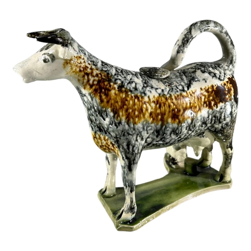 51 - LATE 18TH/ EARLY 19TH CENTURY STAFFORDSHIRE/ YORKSHIRE PEARLWARE COW CREAMER AND MILKMAID
Sponge dec... 