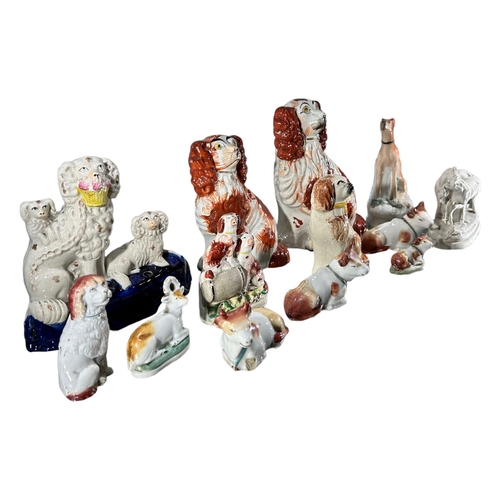 54 - A COLLECTION OF THIRTEEN 19TH CENTURY AND LATER STAFFORDSHIRE/POTTERY ANIMALS
To include dogs, cows,... 