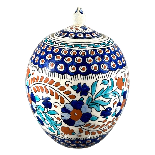 74 - A 20TH CENTURY TURKISH IZNIK POTTERY GLOBE JAR AND COVER
Decorated with floral and geometric banded ... 