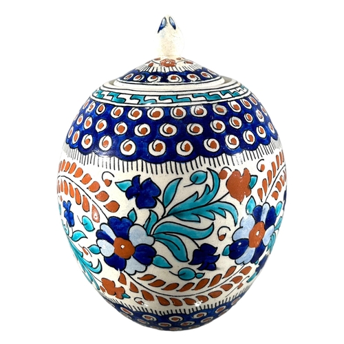 74 - A 20TH CENTURY TURKISH IZNIK POTTERY GLOBE JAR AND COVER
Decorated with floral and geometric banded ... 