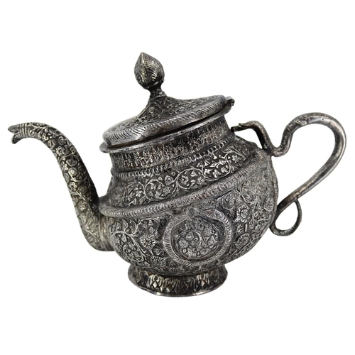 16A - A HEAVY LATE 19TH/EARLY 20TH CENTURY INDIAN RAJ PERIOD KASHMIRI SILVER TEAPOT OF TIPPED KANG FORM
Ch... 