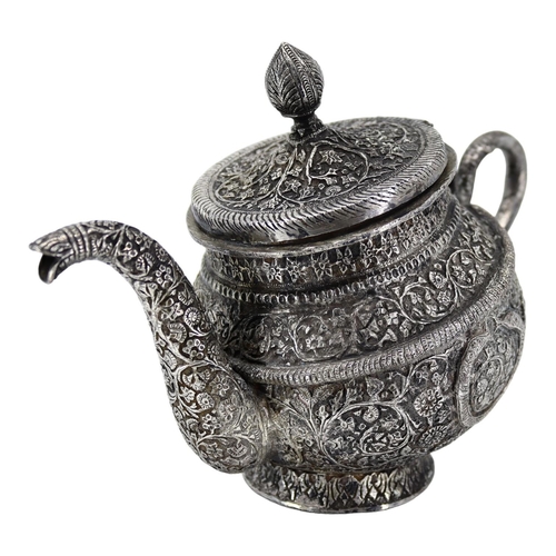 16A - A HEAVY LATE 19TH/EARLY 20TH CENTURY INDIAN RAJ PERIOD KASHMIRI SILVER TEAPOT OF TIPPED KANG FORM
Ch... 