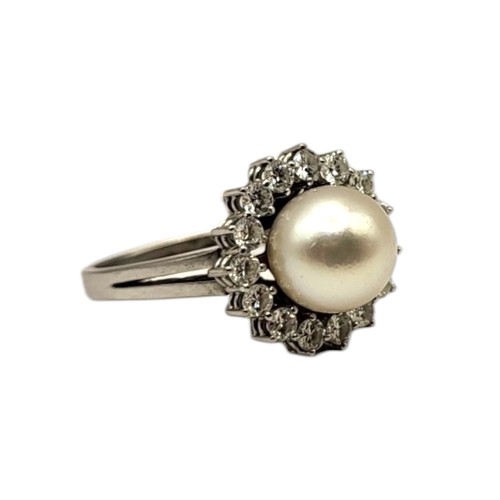 42 - AN 18CT WHITE GOLD, PEARL AND DIAMOND CLUSTER RING
Central pearl (approx. 9mm) surrounded by fifteen... 