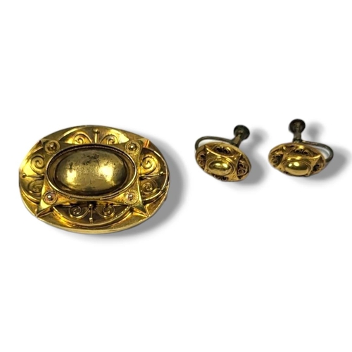 29A - A VICTORIAN 15CT GOLD AND ETRUSCAN REVIVAL OVAL BROOCH AND EARRINGS
Having applied wire decoration, ... 