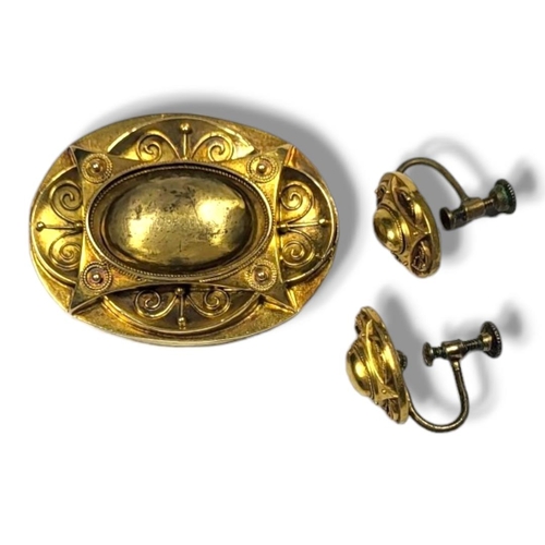 29A - A VICTORIAN 15CT GOLD AND ETRUSCAN REVIVAL OVAL BROOCH AND EARRINGS
Having applied wire decoration, ... 