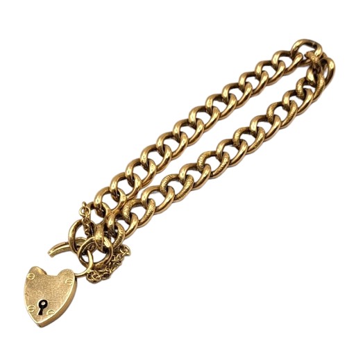 46A - AN EARLY 20TH CENTURY 9CT GOLD CURB LINK HEART PADLOCK CLASPED BRACELET
Each link having textured fr... 