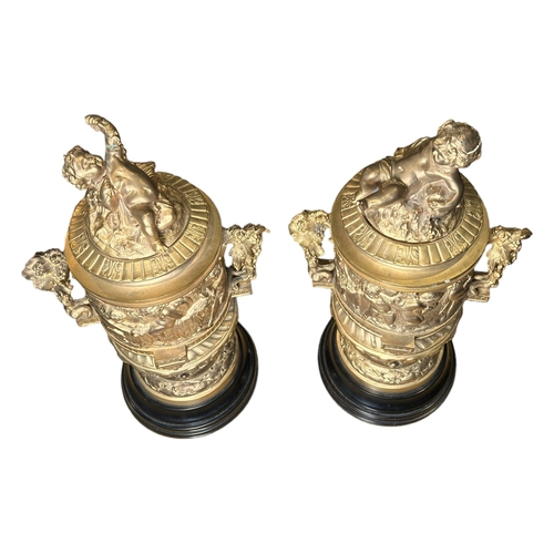 184A - A PAIR OF FRENCH REGENCY DESIGN GILDED BRONZE LIDDED URNSDecorated with Neoclassical scenes, putti f... 