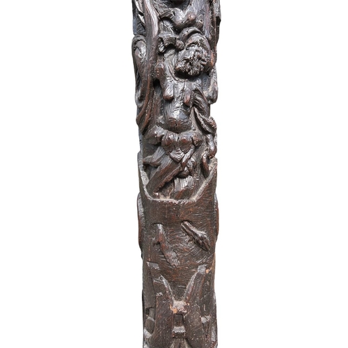 205 - A RARE 16TH CENTURY CARVED OAK COLUMNDecorated with with a grotesque facial figure above Satyress, e... 