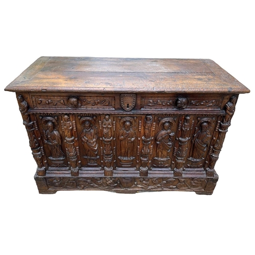 207 - A 16TH CENTURY FRENCH, OAK COFFER with hinged lid above carved freeze decorated with swags and mount... 