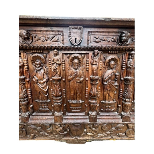 207 - A 16TH CENTURY FRENCH, OAK COFFER with hinged lid above carved freeze decorated with swags and mount... 