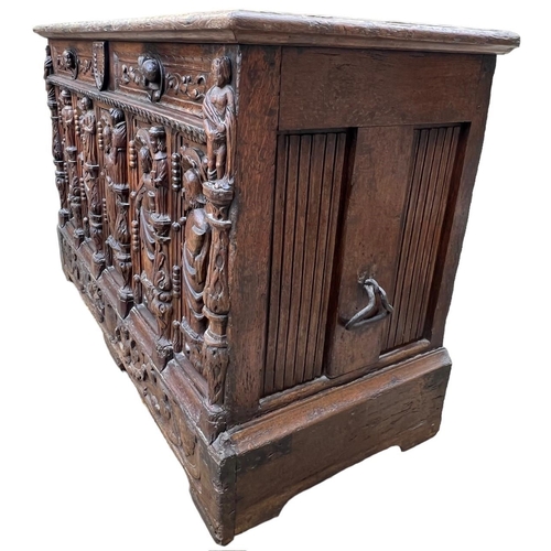 207 - A 16TH CENTURY FRENCH, OAK COFFER with hinged lid above carved freeze decorated with swags and mount... 