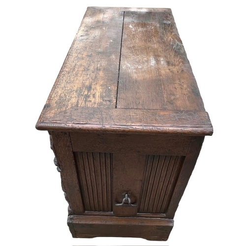 207 - A 16TH CENTURY FRENCH, OAK COFFER with hinged lid above carved freeze decorated with swags and mount... 