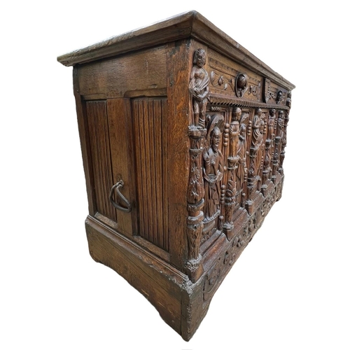 207 - A 16TH CENTURY FRENCH, OAK COFFER with hinged lid above carved freeze decorated with swags and mount... 