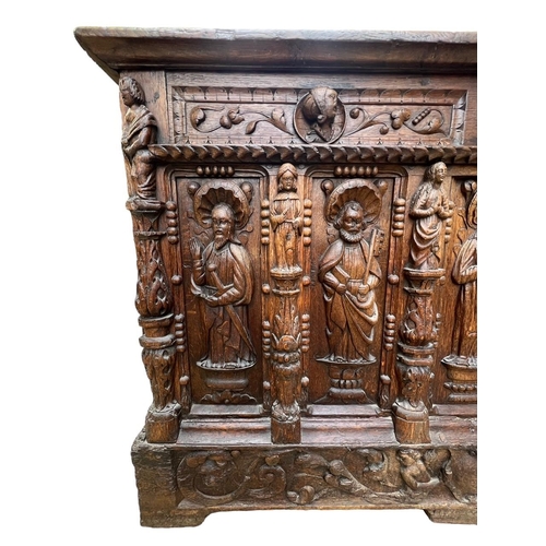 207 - A 16TH CENTURY FRENCH, OAK COFFER with hinged lid above carved freeze decorated with swags and mount... 