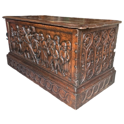 211 - A RARE 15TH CENTURY FRENCH CARVED WALNUT COFFER,With hinge lid above carved panel in relief with a k... 