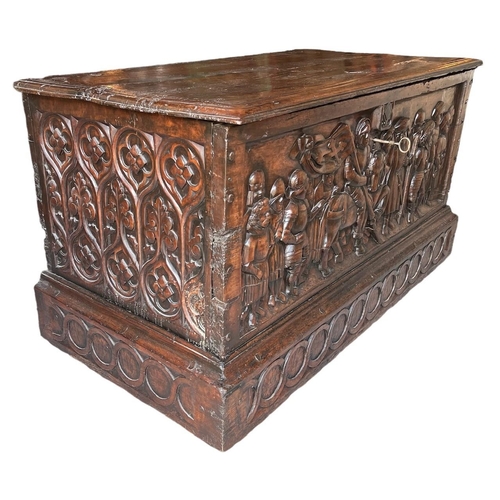 211 - A RARE 15TH CENTURY FRENCH CARVED WALNUT COFFER,With hinge lid above carved panel in relief with a k... 