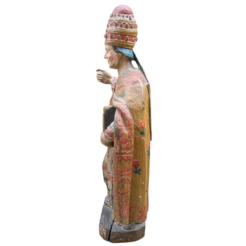 215 - A LARGE 16TH/17TH CENTURY CARVED WOOD POLYCHROME AND GILDED STATUE OF A POPEWearing the triple tiara... 