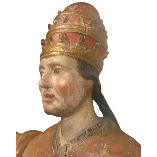 215 - A LARGE 16TH/17TH CENTURY CARVED WOOD POLYCHROME AND GILDED STATUE OF A POPEWearing the triple tiara... 