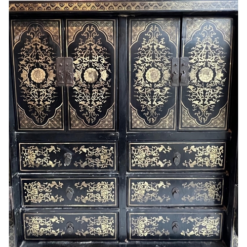 217 - A CHINESE BLACK LACQUERED AND GILT PAINTED TABLE TOP CABINETThe pair of doors opening to reveal cupb... 