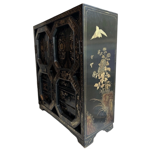 217 - A CHINESE BLACK LACQUERED AND GILT PAINTED TABLE TOP CABINETThe pair of doors opening to reveal cupb... 