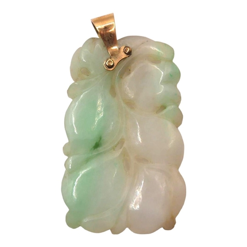 11 - A CHINESE CARVED JADE AND YELLOW METAL PENDANT (YELLOW METAL TESTED AS 14CT YELLOW GOLD)
Carving sho... 