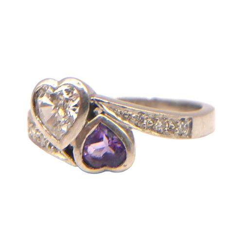 21 - A VINTAGE PLATINUM, DIAMOND AND AMETHYST HEART FORM RING
Bezel set Heart cut diamond and amethyst (d... 