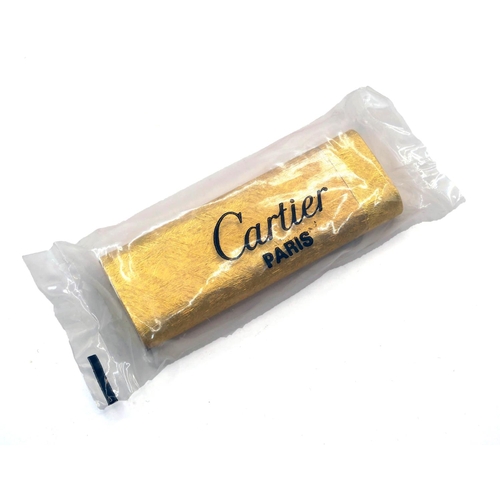 22 - CARTIER, A VINTAGE GOLD PLATED LIGHTER, UNOPENED CELLOPHANE
Housed in a box, complete with paperwork... 