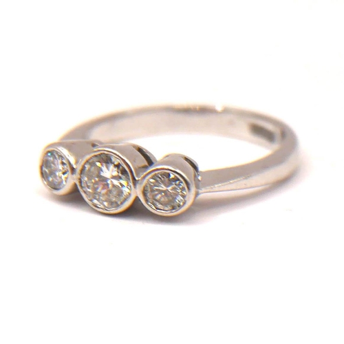 25 - A VINTAGE 18CT WHITE GOLD AND THREE STONE DIAMOND RING
Bezel set brilliant round cut diamond (approx... 